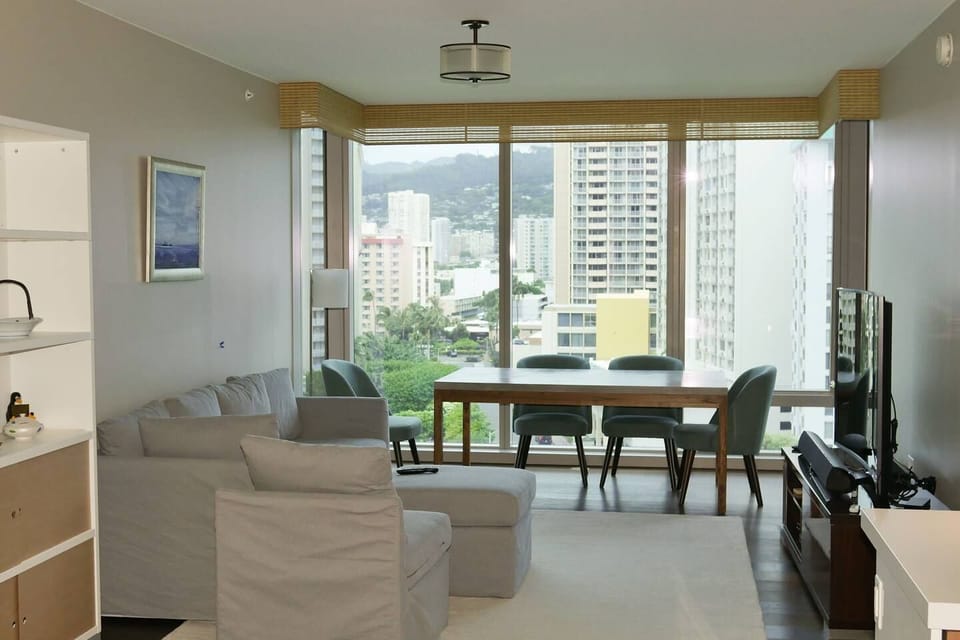 Bright living room, with Remote controlled drop down curtains. 

