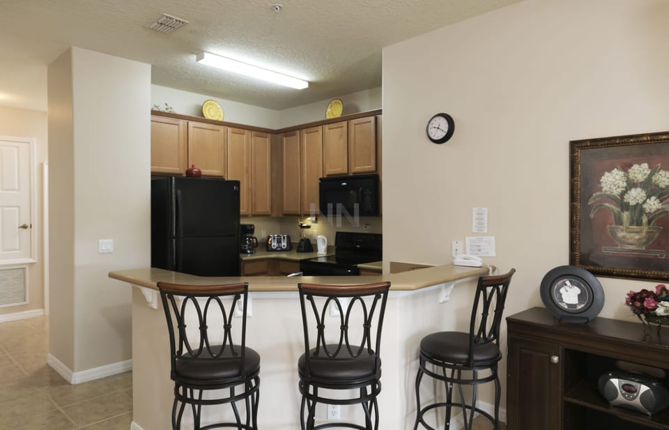 Gather around the stylish kitchen with a convenient countertop 