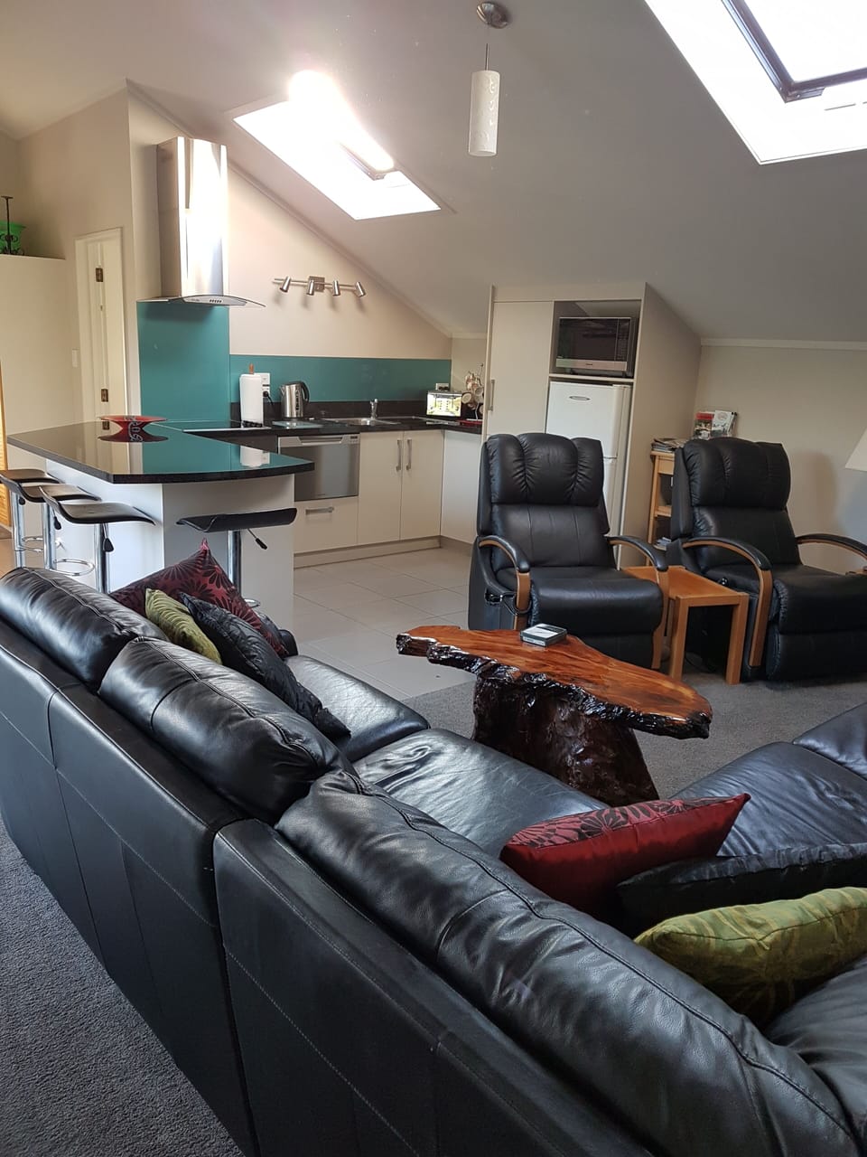 lounge looking through to kitchen, chairs are electric lazyboys