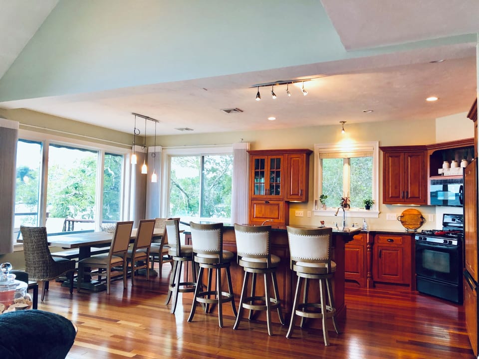 Kitchen view of island and dining table that seats 10.