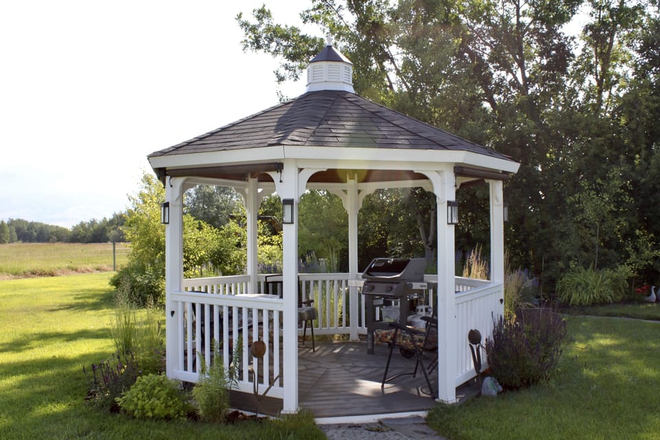 gazebo for your enjoyment of the outdoors. shades for sun and privacy 