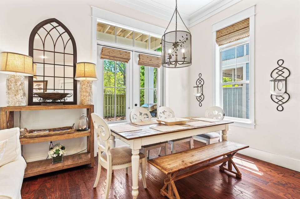 Dining seating for six under an ornate light fixture