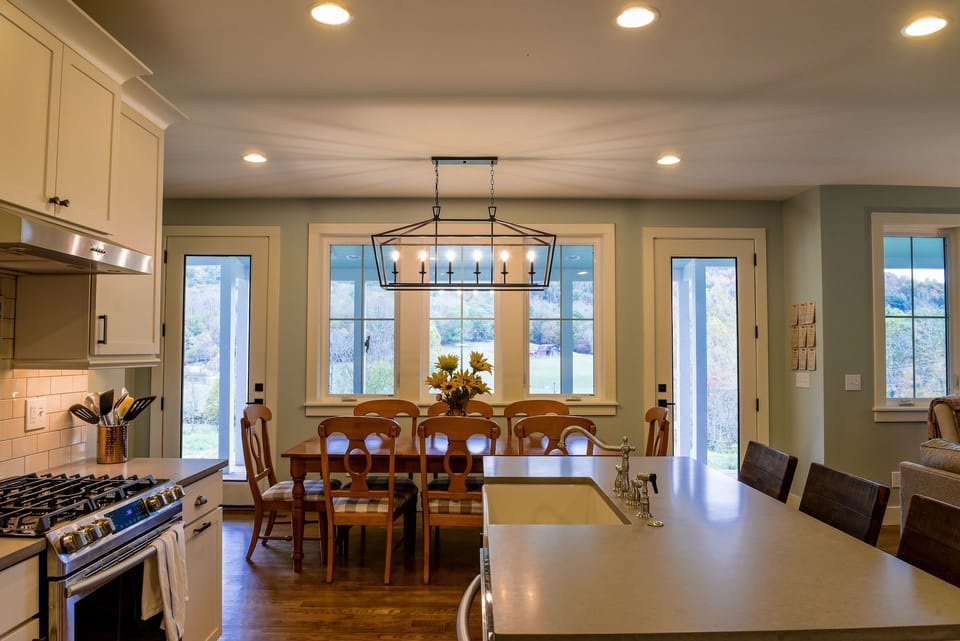Dining table seats 8 with windows that span the entire length of the house. 