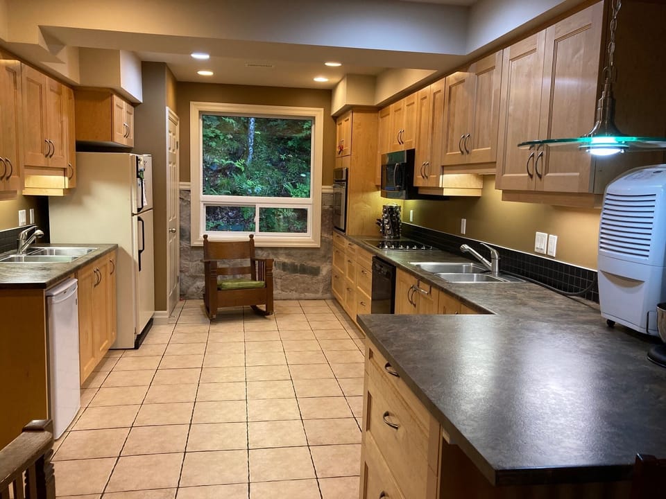 Closet beside the kitchen window and seating has washer/dryer stack.