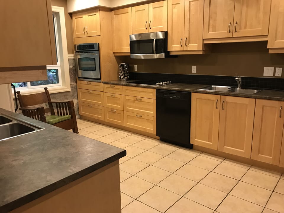Kitchen:  two double sinks, microwave, stove top, oven, dishwasher