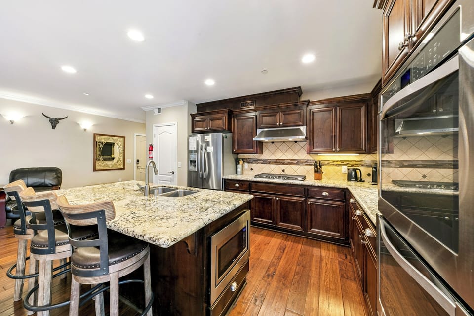 Your gourmet kitchen awaits with granite counters, rich cabinetry, and premium appliances—perfect for creating memorable meals during your stay.