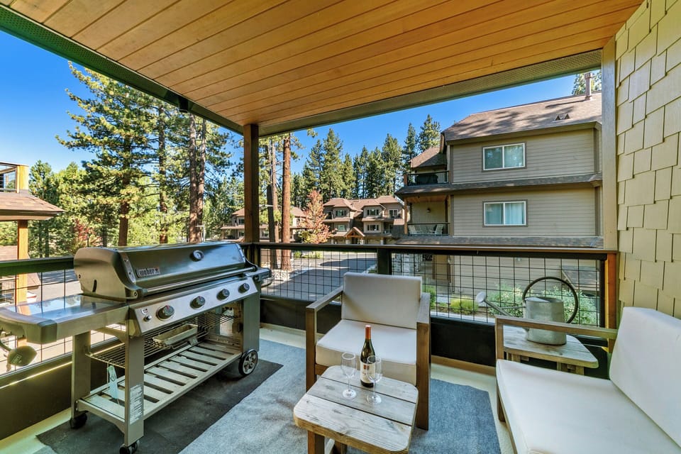 Relax on your private balcony with mountain air, BBQ grill, and cozy seating overlooking peaceful wooded surroundings.