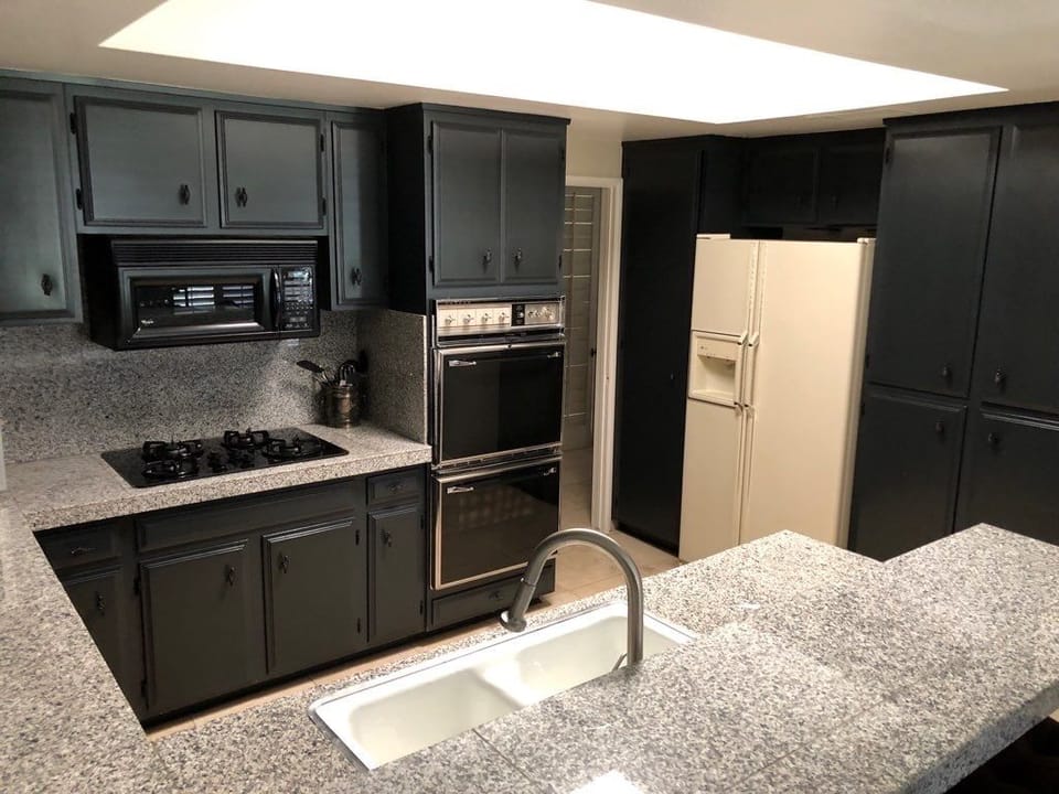 granite kitchen new appliances. new fridge is stainless steel
