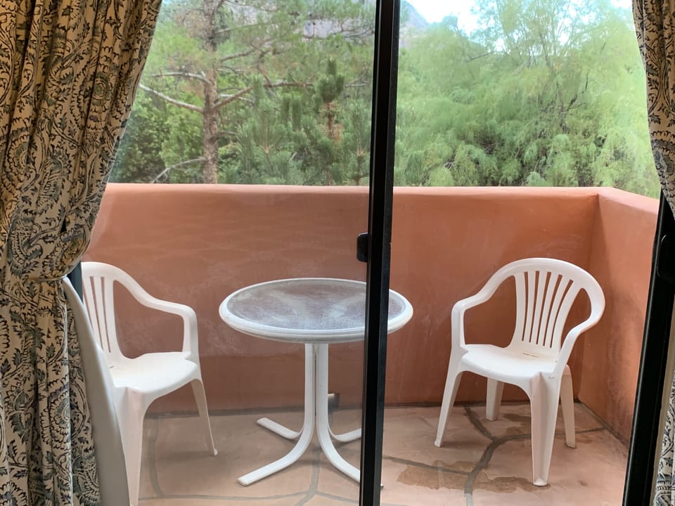 Private balcony sitting area in master bedroom with beautiful red rock views.