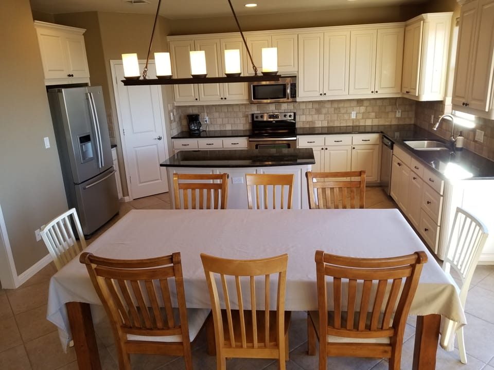 Large farm table with sitting up to 8 plus a card table to seat another 4. 
