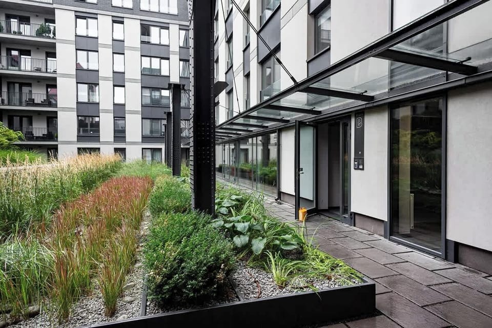 Modern property building with a greenery located next to the object.