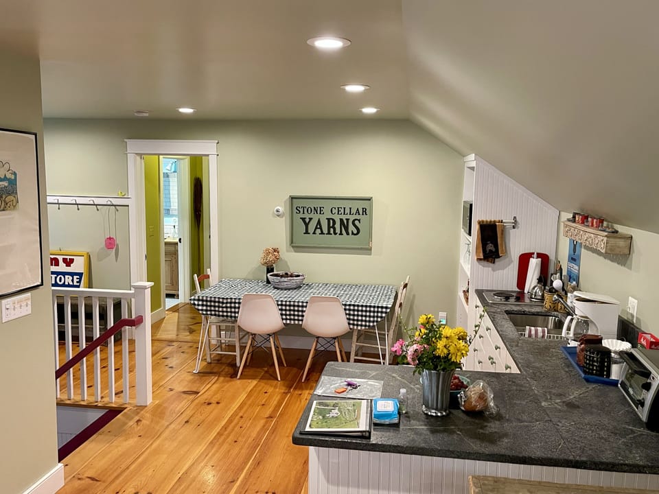 Landing area with kitchenette and view towards private bathroom