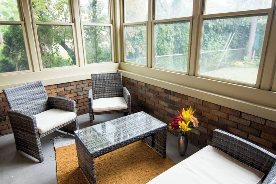 Relish outdoors from the comfort of indoors!! This three-season sitting room off of the living room is a great place to enjoy some peace and quiet! 