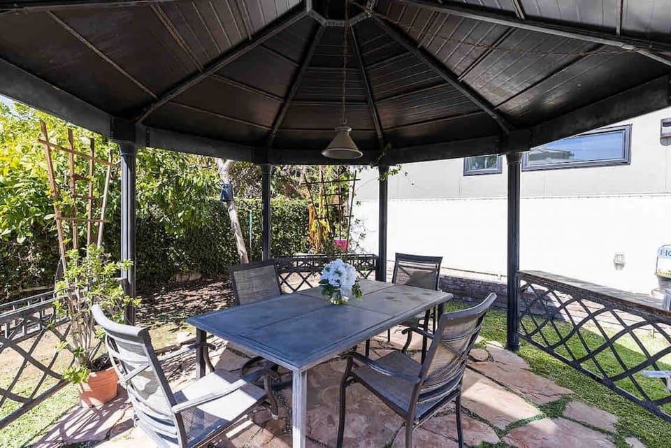 Enjoy the breeze and shaded comfort in this cozy outdoor nook.