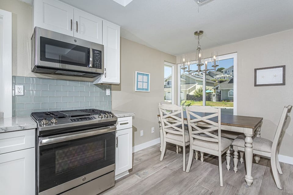 View from kitchen into front yard. Magnetic shades now provide optional privacy.