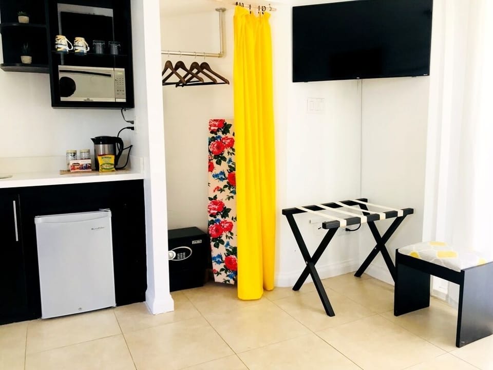 Kitchenette with Microwave,sink,fridge,kettle, room safe, iron board, hd tv