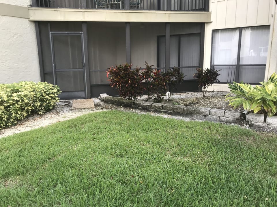 Back side screened patio; ground floor unit, only 1 shared wall