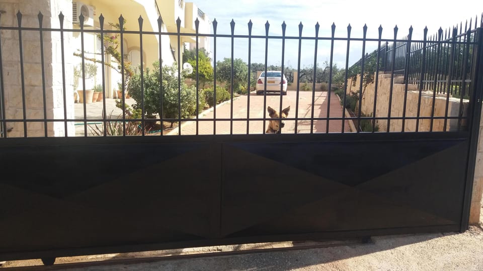 Parking area with automatic gate and security cameras..
