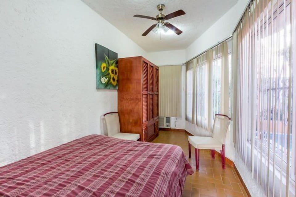 Small alcove Bedroom 4 upstairs has full size bed and large windows overlooking the pool