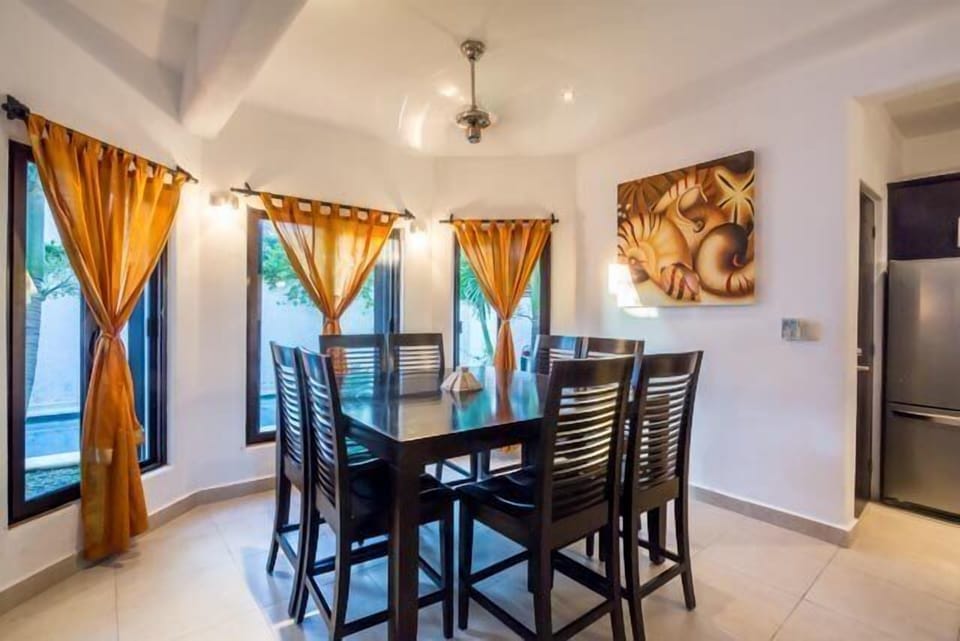 Dinning table seats 8 people and overlooks backyard pool