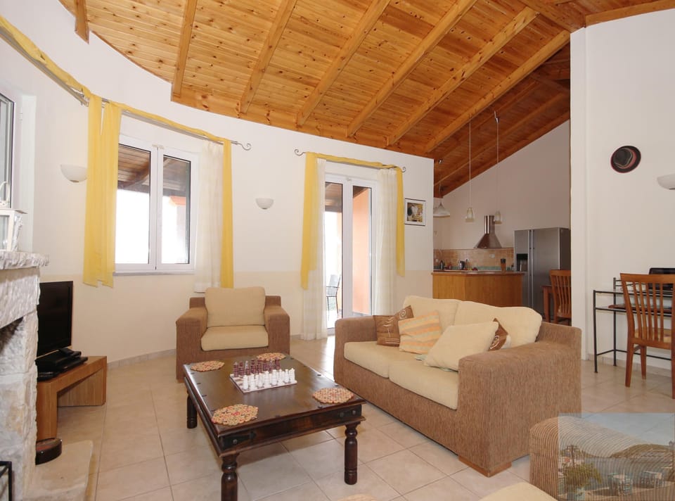 Comfortable lounge with patio doors to large covered veranda for dining/relaxing