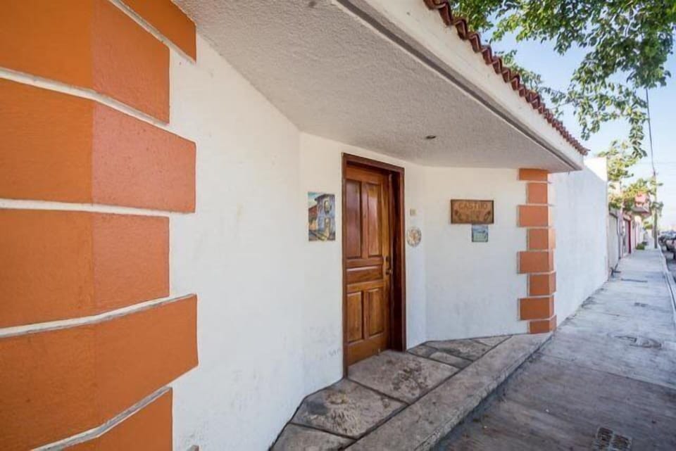 Front entrance and private wall surround the property