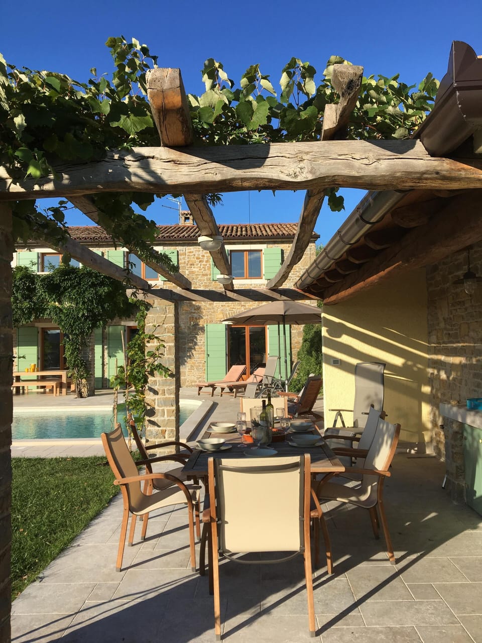 The outside dining area showing the vines shading the table