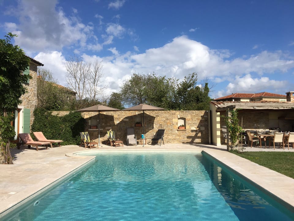 The pool showing the outside kitchen and pergola