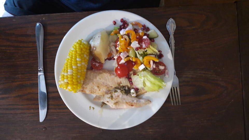 Enjoying dinner of fresh fish, spuds, salad and corn.
