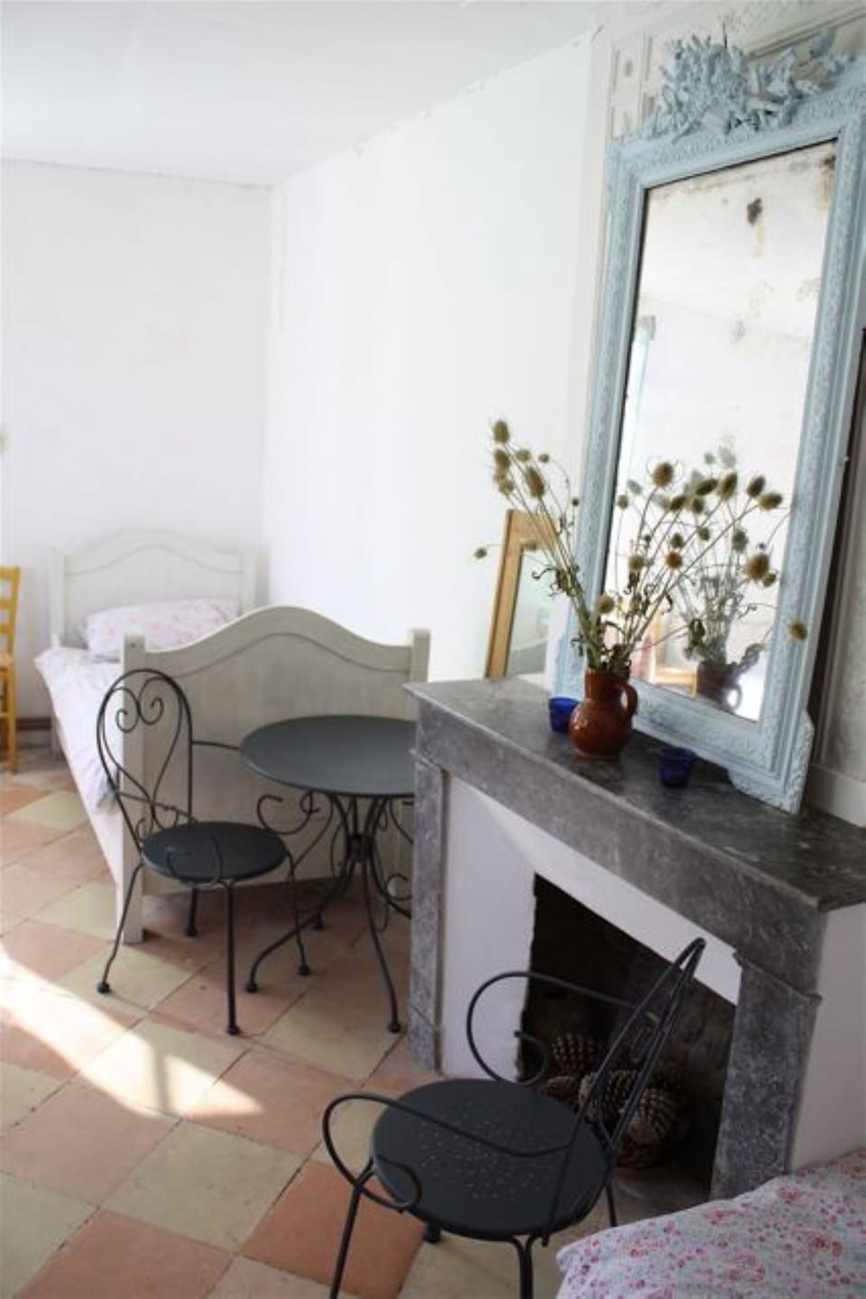 Bedroom 4. Fireplace & harlequin terracotta floor.