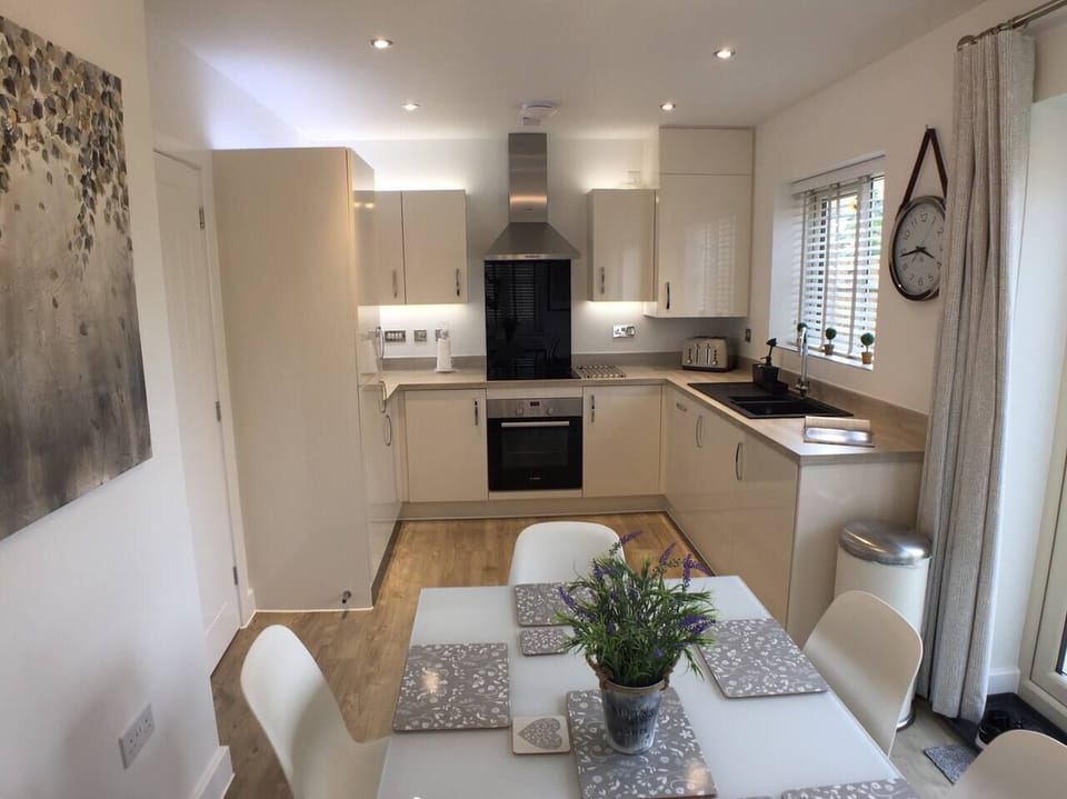 Bright modern kitchen diner with French doors opening onto the garden. High chair available on request.