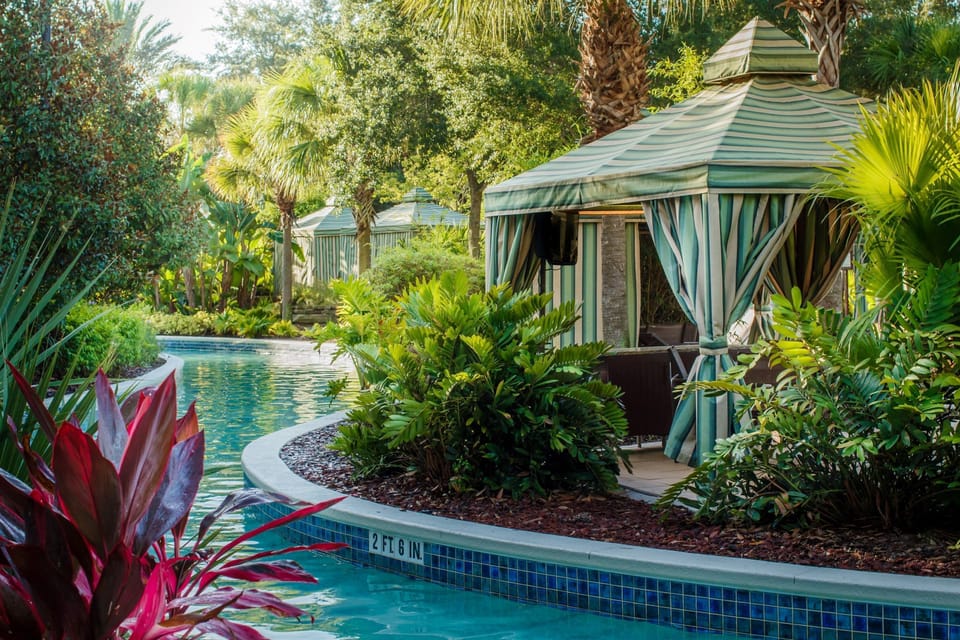 Unwind in a private cabana as you soak in the vibrant greenery and shimmering pool waters.