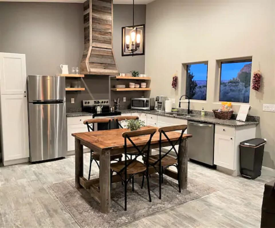 The full-size kitchen includes a refrigerator, electric stove and dishwasher. 