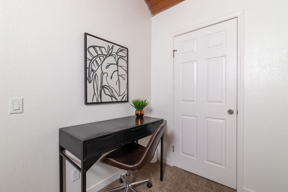 Upstairs 5th bedroom with office desk and chair.