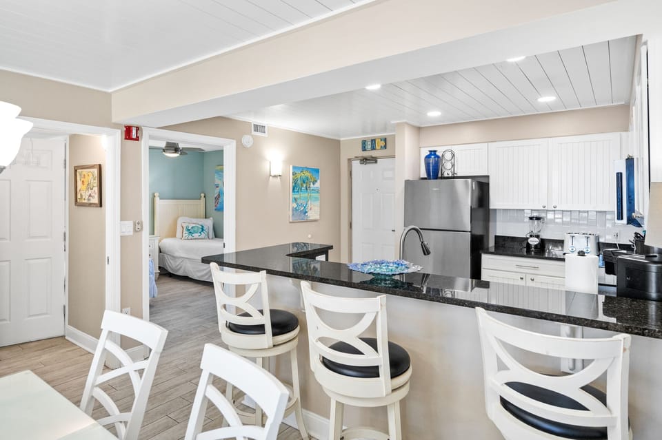 Kitchen area with bar and seating for three guests