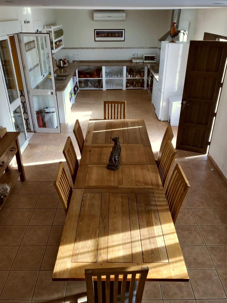 Ample seating at Spanish Oak Dining Table leading off to fully equipped kitchen.