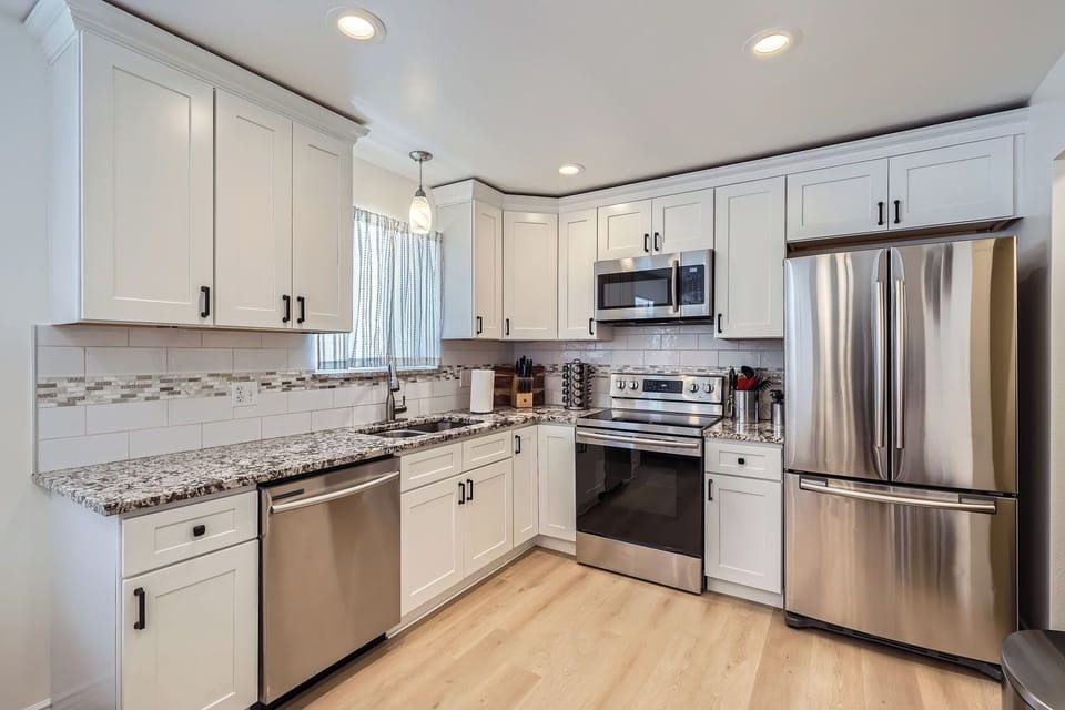 Stylish white shaker cabinets, granite counters and stainless steel appliances.
