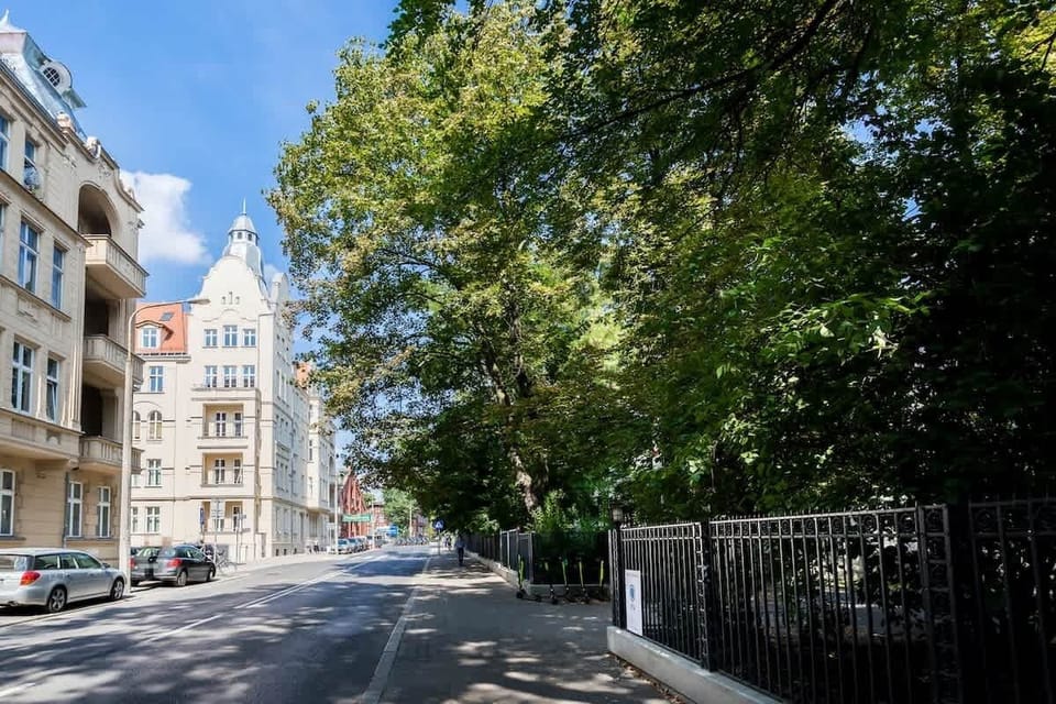 Surrounding area with greenery and many atmospheric buildings and amenities.