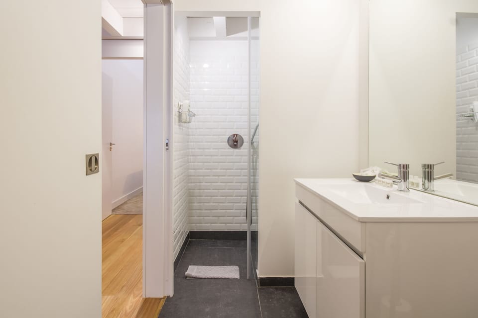 Bathroom with rain shower head and hand-held shower device.