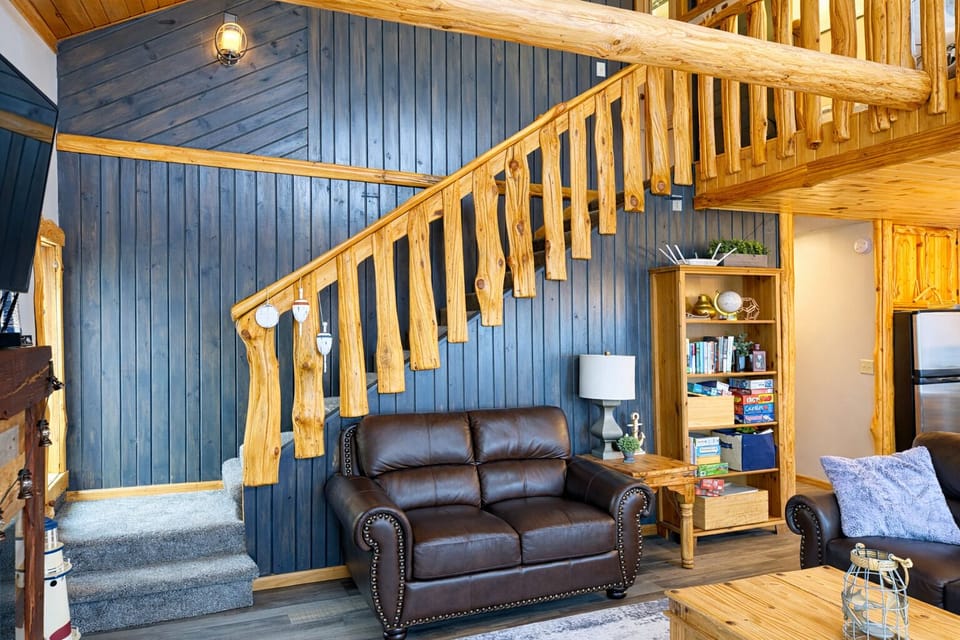 Open staircase right off the living room leads up to the loft. The connected layout that keeps everyone close while still offering cozy spots upstairs.