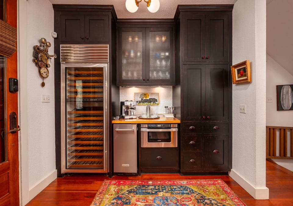 Wine cooler and coffee bar with espresso machine.
