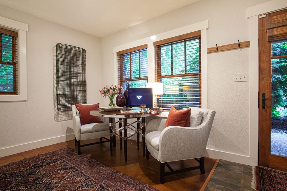 Lower-level bedroom with king-size bed, TV, and sitting area.