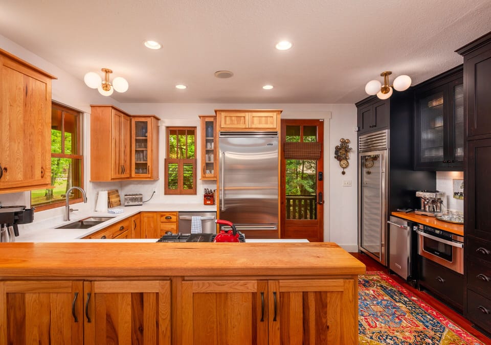 Chef's kitchen with a gas range, dishwasher, and Keurig coffeemaker.
