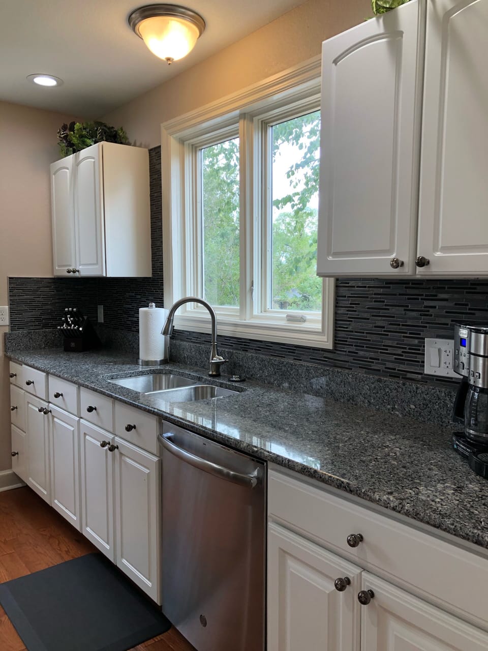 Spacious granite countertops allow for food, baking prep.