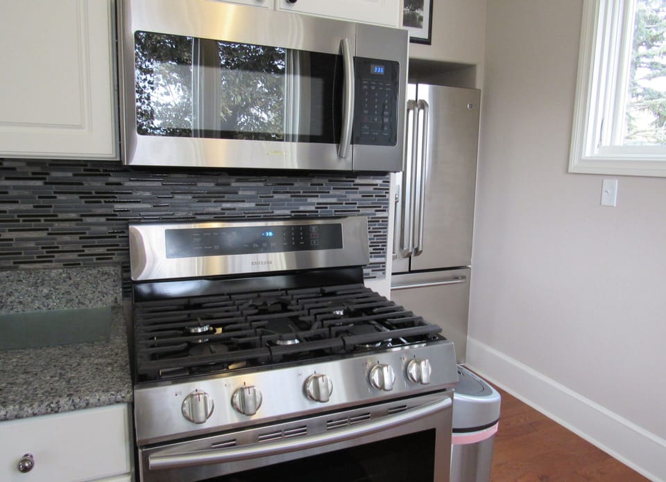 Kitchen with new gas stove and microwave.