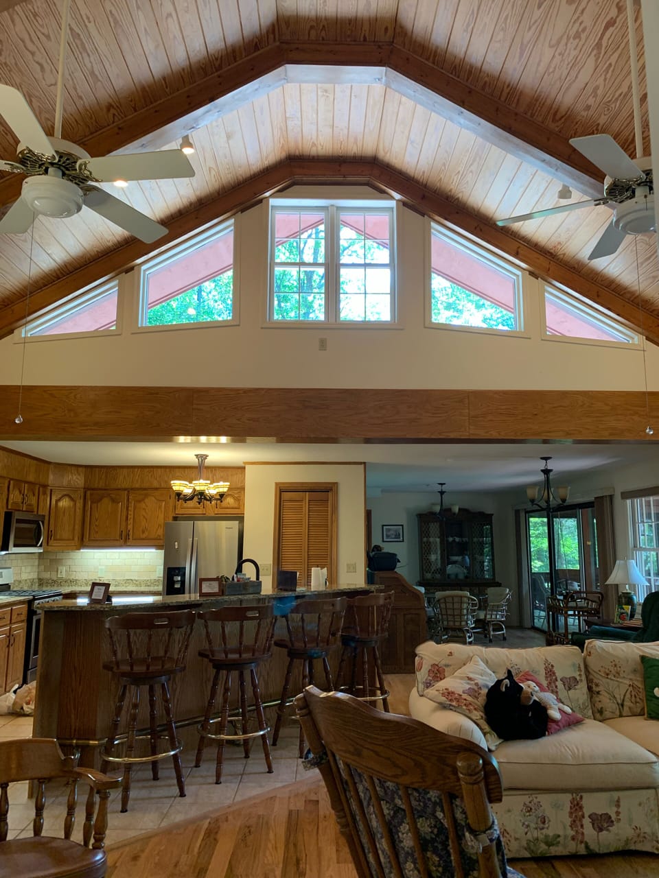 Living room, kitchen with bar seating, and two dining areas 