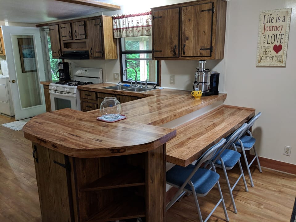 Fully supplied kitchen with pots, pans, dishes, coffee pot, juicer, and more!