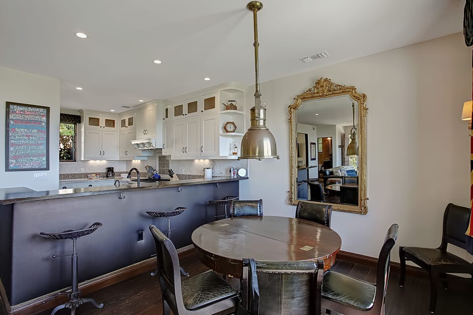 Kitchen offers seating at the breakfast bar and dining table.