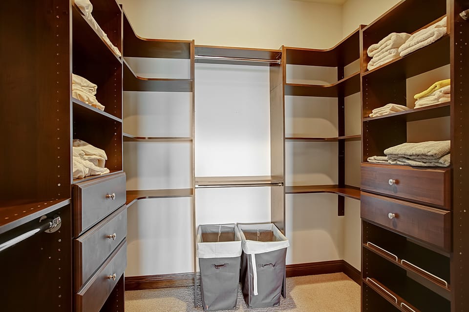 Walk in closet in the primary bedroom is spacious and well organized.