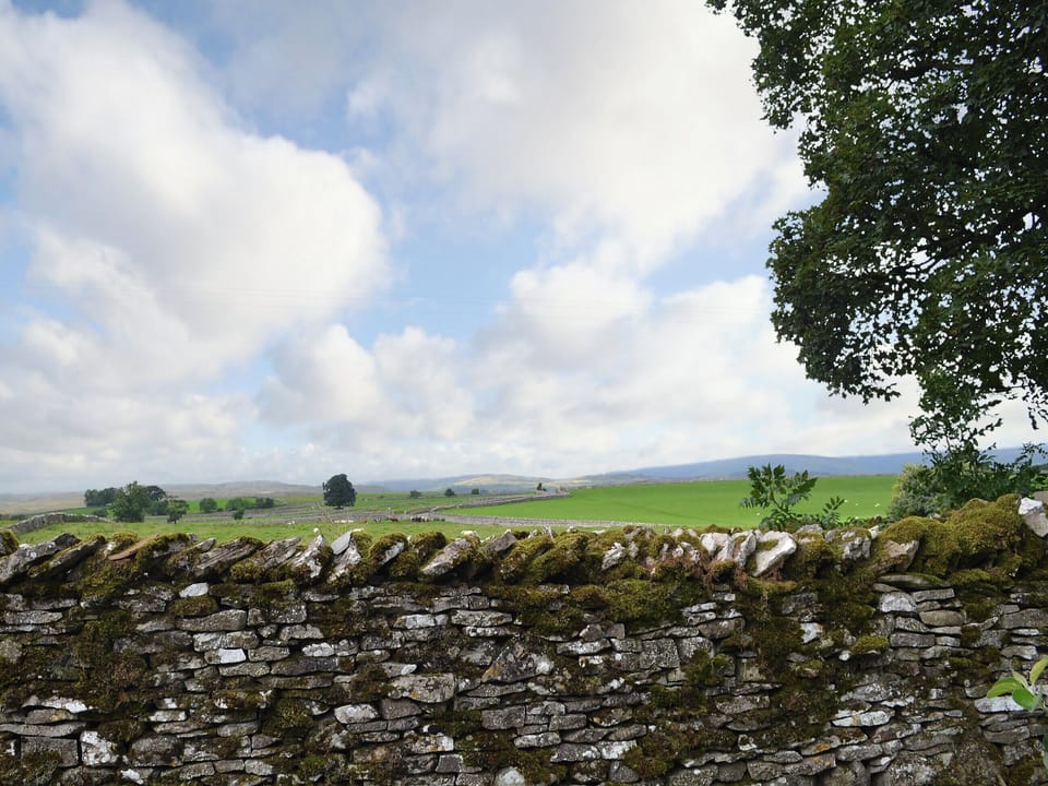 There are expansive views over rural countryside towards the distant hills | The Rockery - Rockery Cottages, Shap, near Penrith